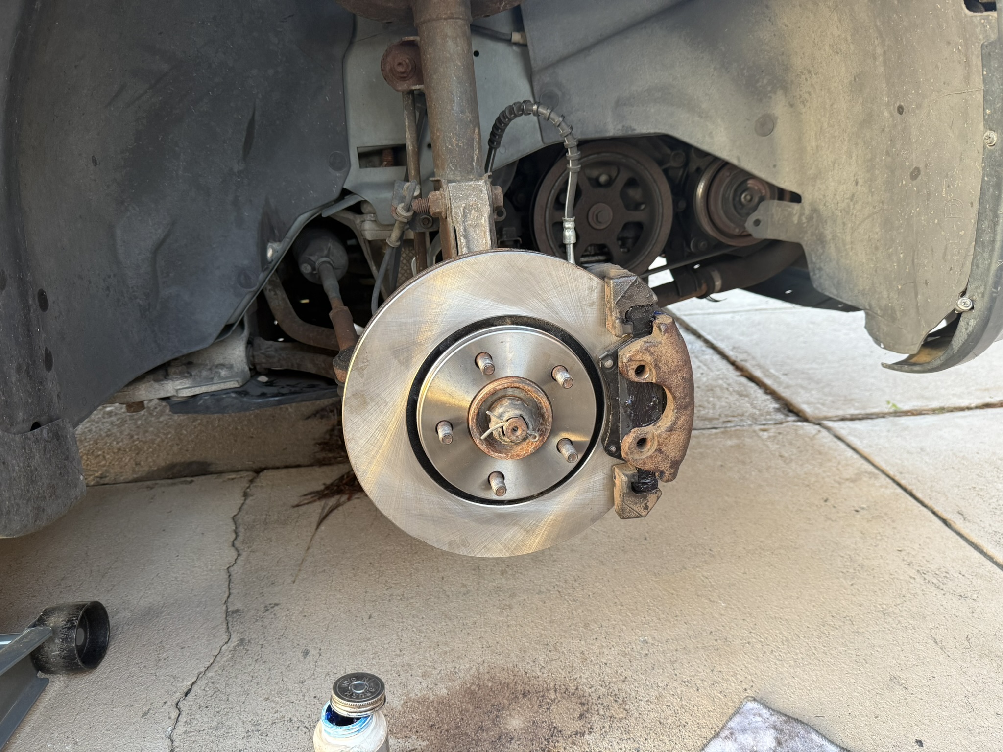 Fresh brake rotor installed during mobile auto repair service